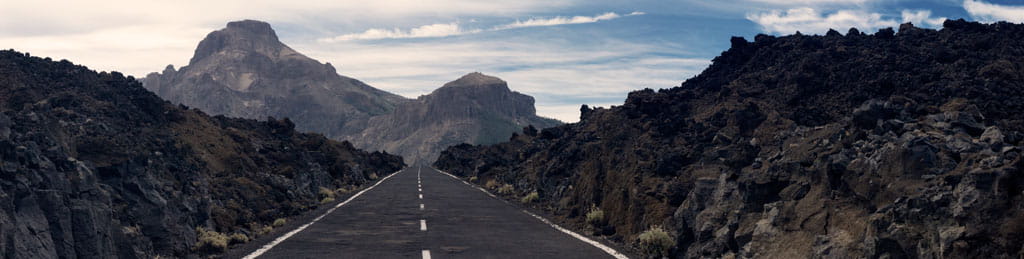 Road between volcanic rocks in Teide National Park, Tenerife.