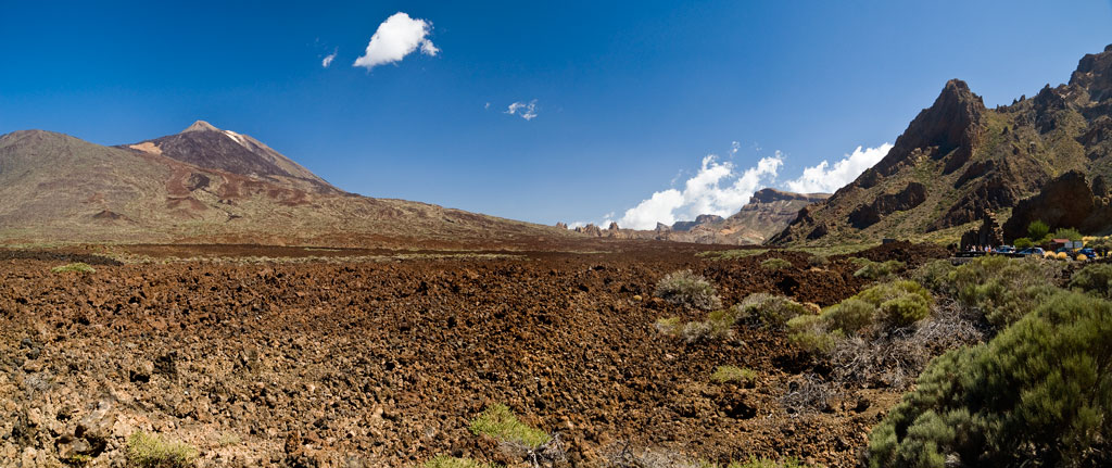 Volcanic landscape with Mount Teide in the background in Tenerife under a clear sky.
