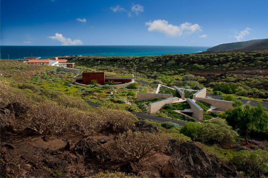 Visitor centre in Punta de Teno, Tenerife, surrounded by greenery and sea in the background.