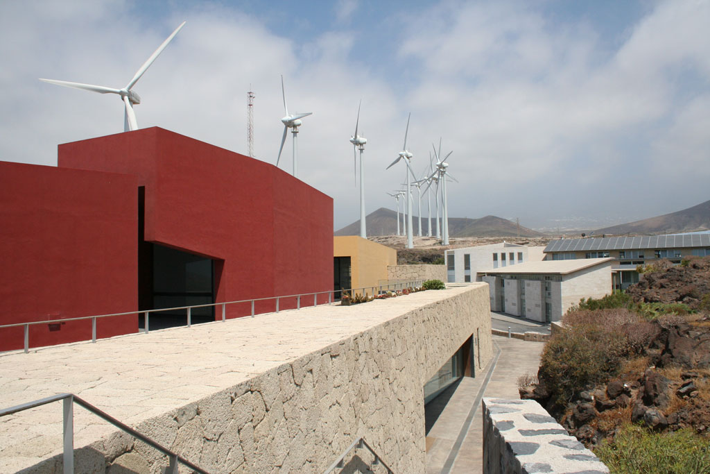 Modern buildings and wind turbines in a landscape of Tenerife.