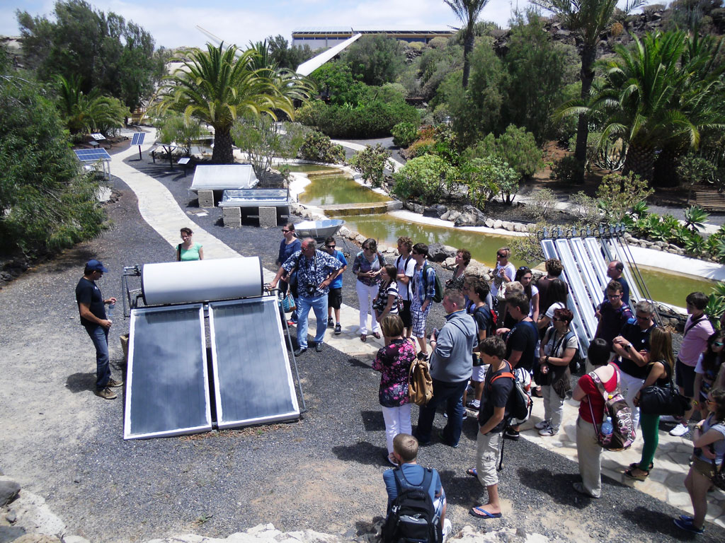 Group of people observing solar panels in a park in Tenerife.