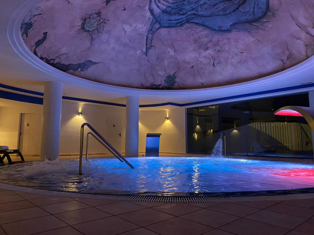 Illuminated indoor pool with decorative roof in Tenerife.