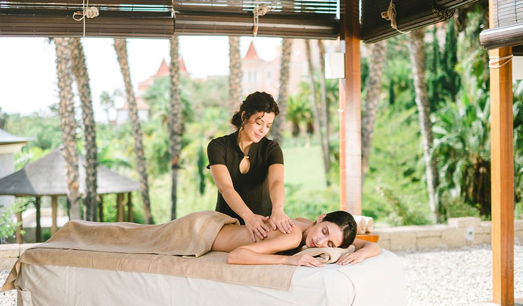 Masseuse performing massage in an outdoor spa in Tenerife.