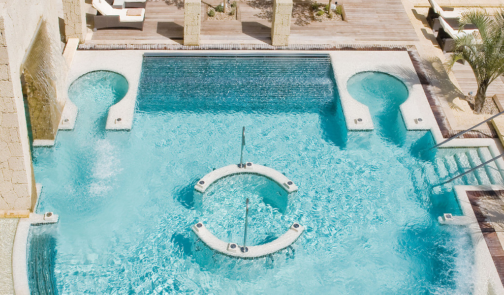 Swimming pool with waterfalls and circular areas in a hotel in Tenerife.