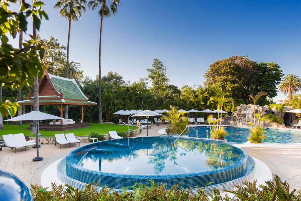 Pool and cabana in a tropical setting in Tenerife.