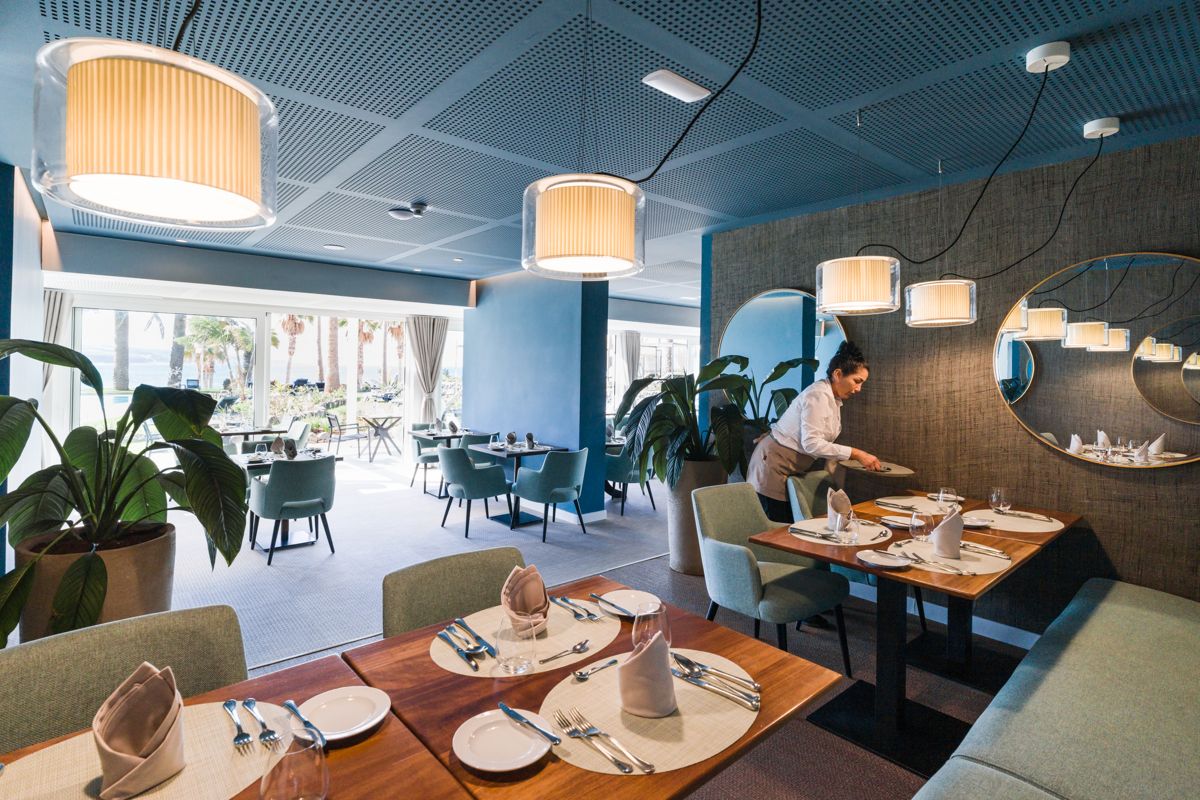Restaurant in Tenerife with tables arranged and staff organizing the service.