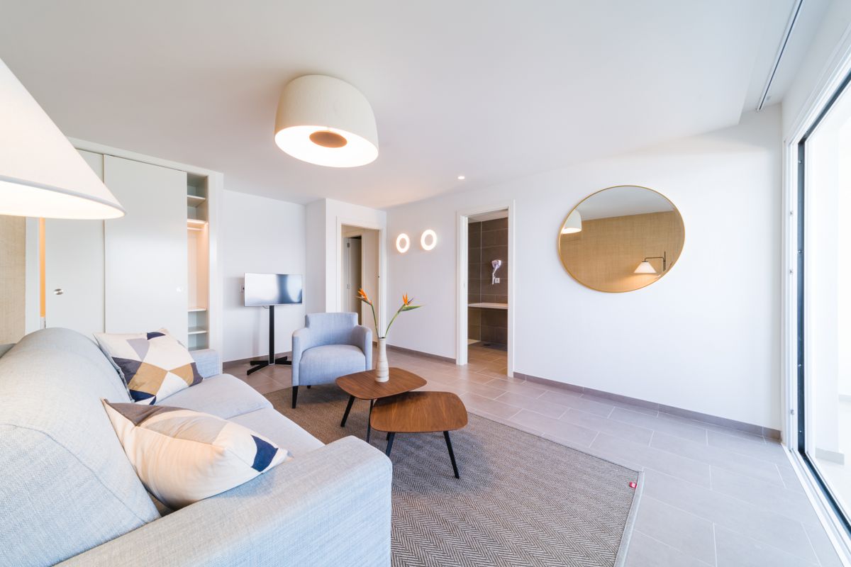 Modern living room with sofa, chair, coffee table and TV, Tenerife.