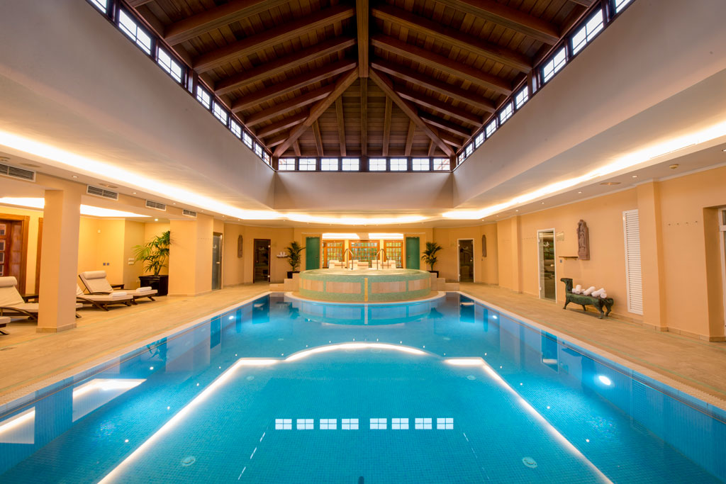 Indoor swimming pool with wooden roof in Tenerife's spa.